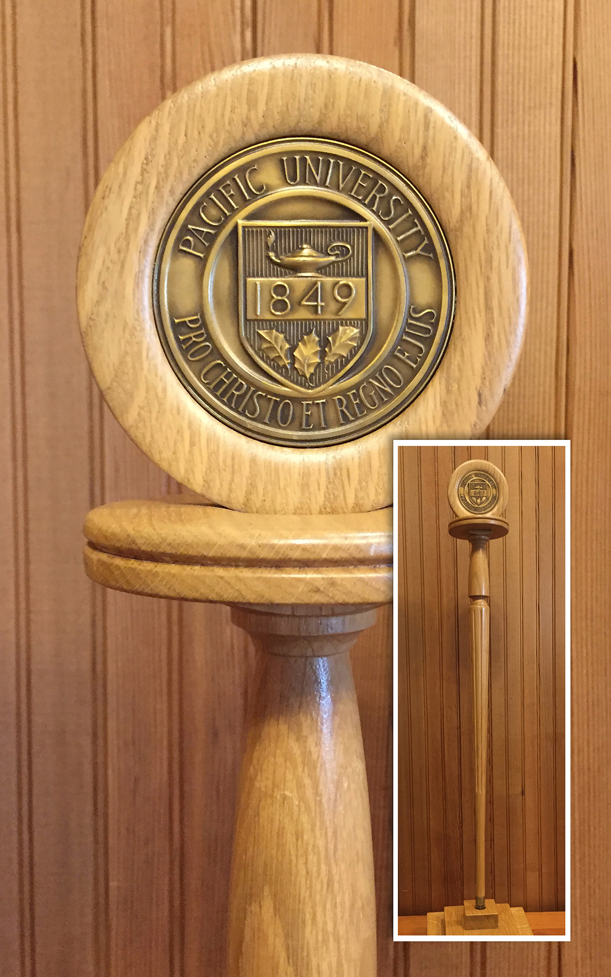 Wooden staff with a brass university seal topper