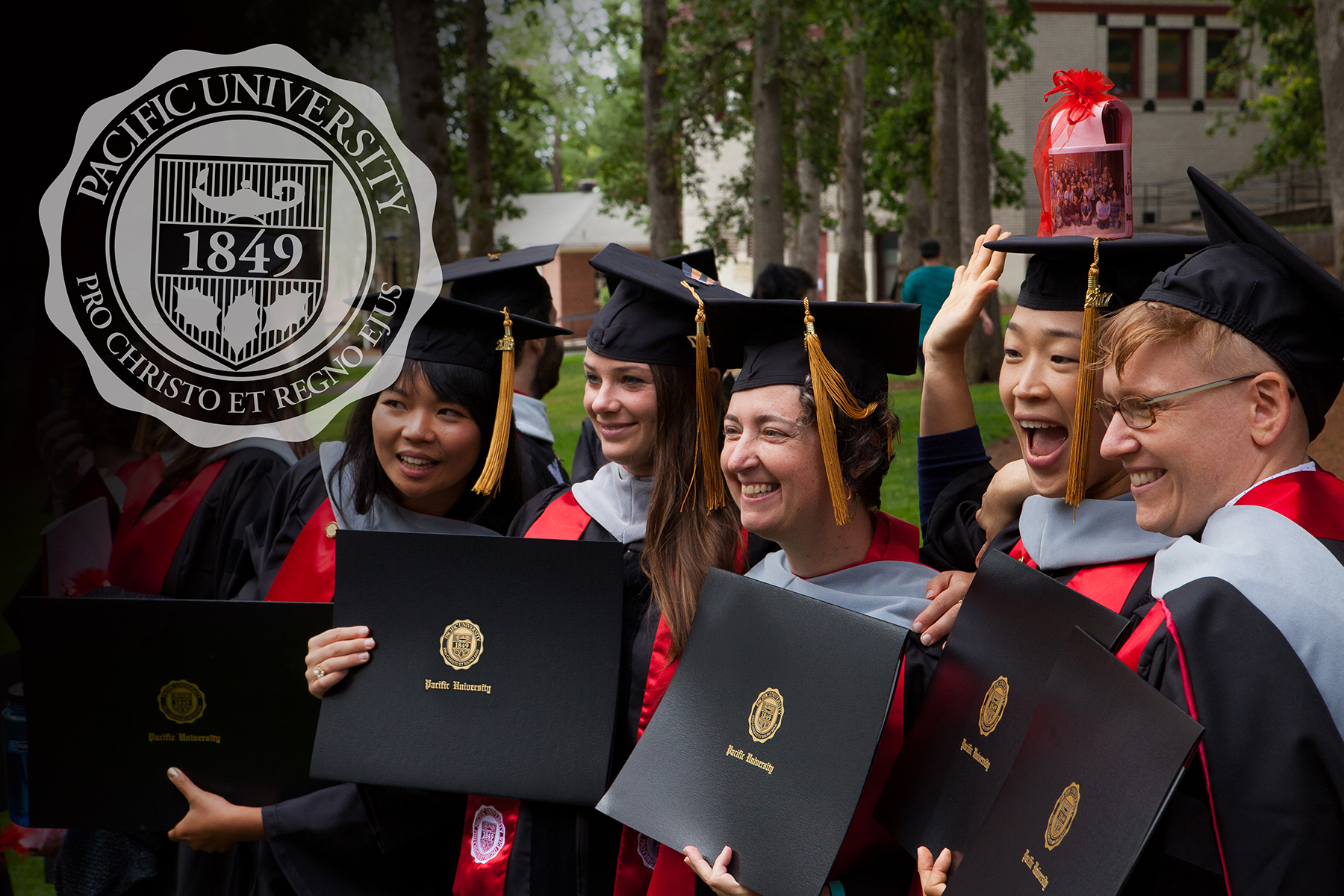 University Seal overlay on a group of happy grads holding diplomas with the seal