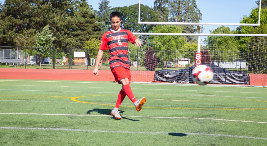 Weli Alamillo kicks a soccer ball