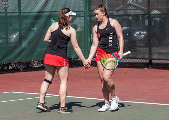 Cassidy & Syndie Binder high-fiving on the tennis court