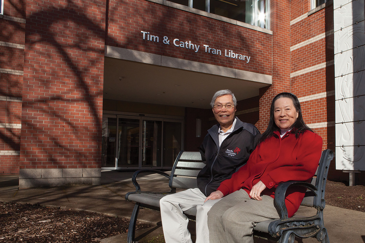 Tim & Cathy Tran seated outside the Library