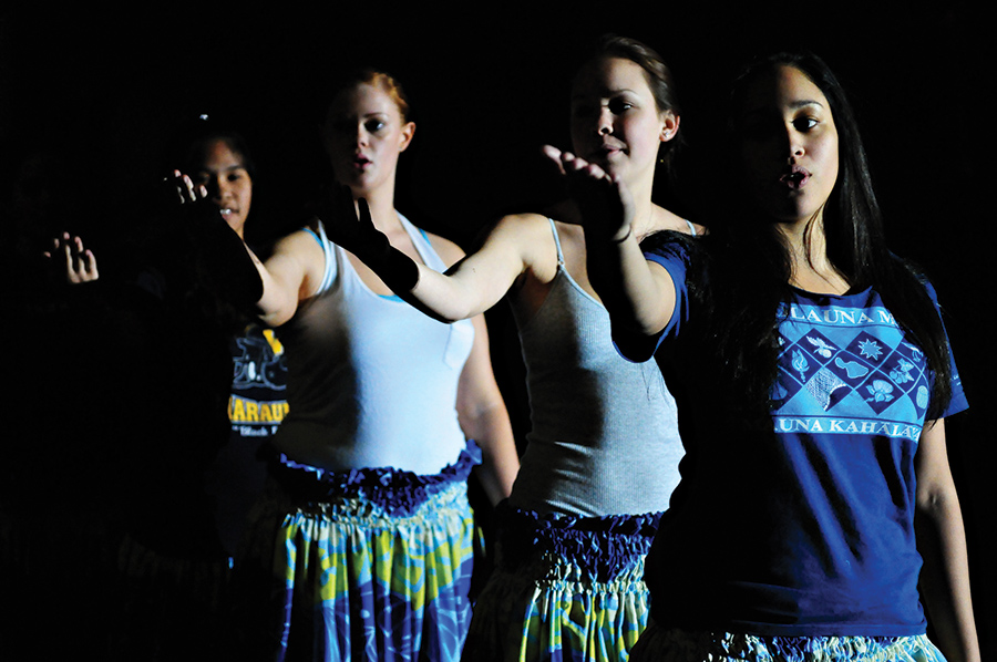 Luau Dancers performing together on stage.