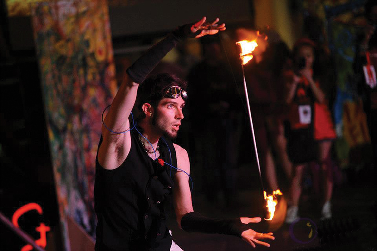 Iain Culp performing with fire