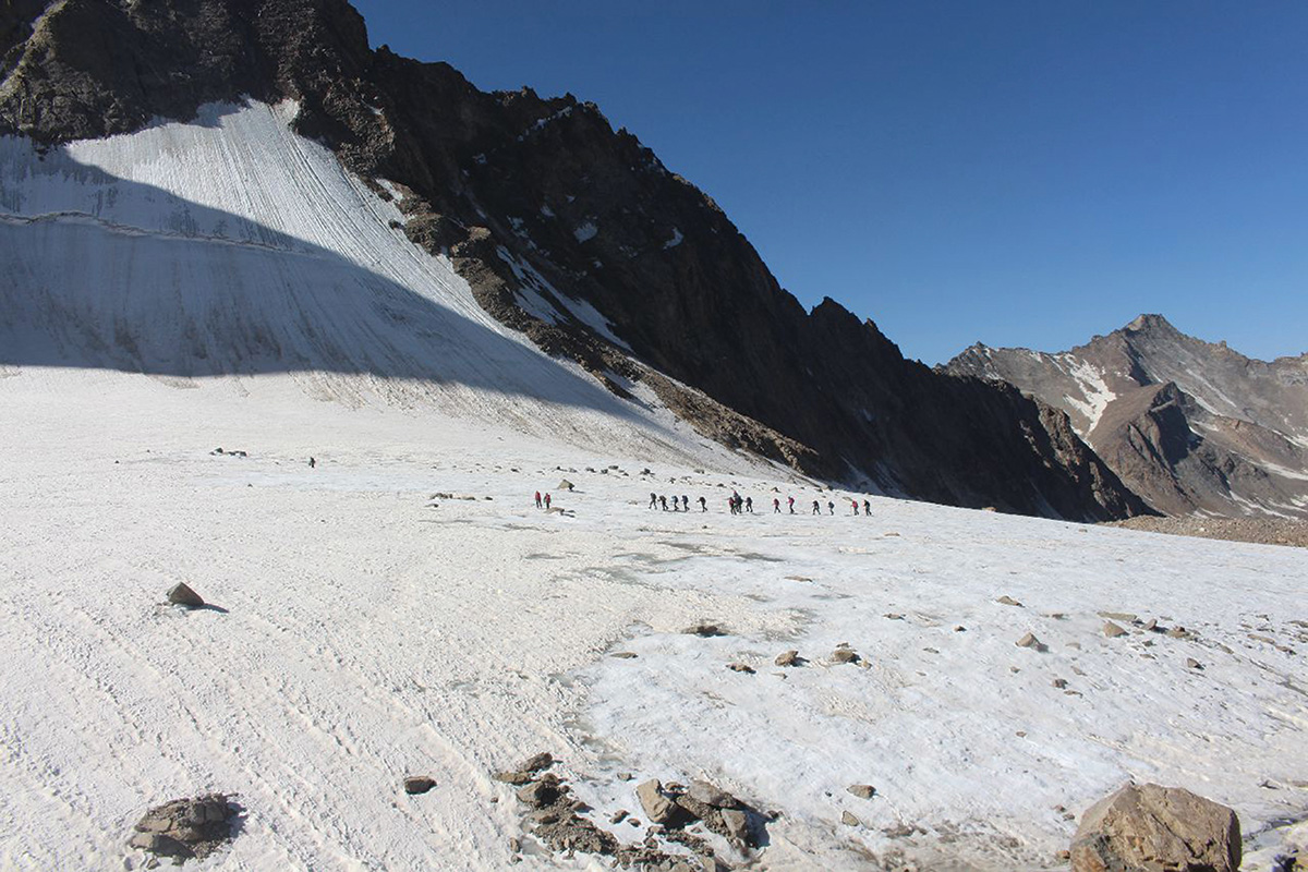 Individuals climbing up the mountain.
