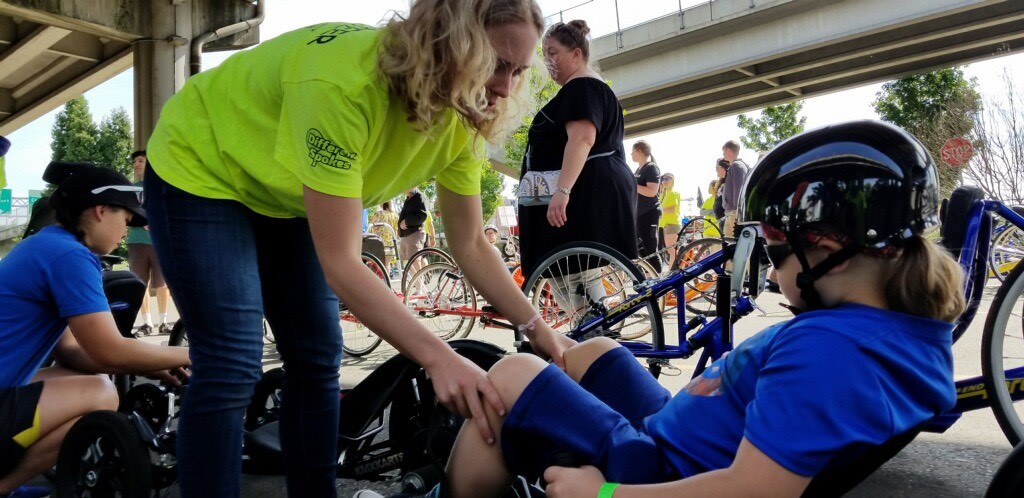 Ellen Key (’20) works with a child in an adapted recumbent bicycle.