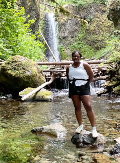 Picture of AT Ambassador Alyssa Ross standing in front of a waterfall