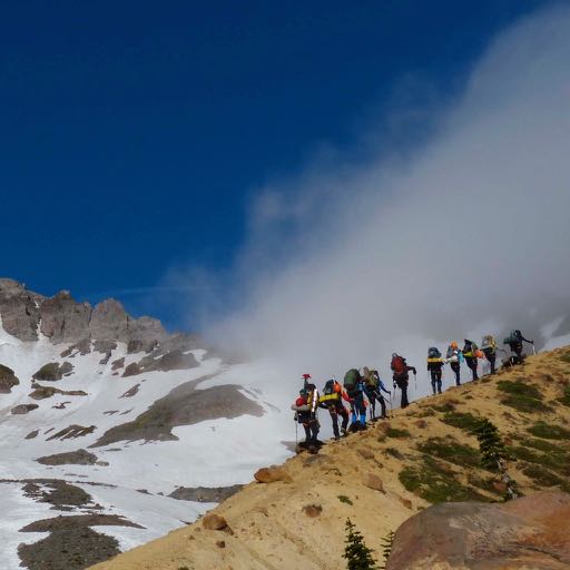 Students and leaders hiking up the ridge of Mt. Rainier during a climb in 2016