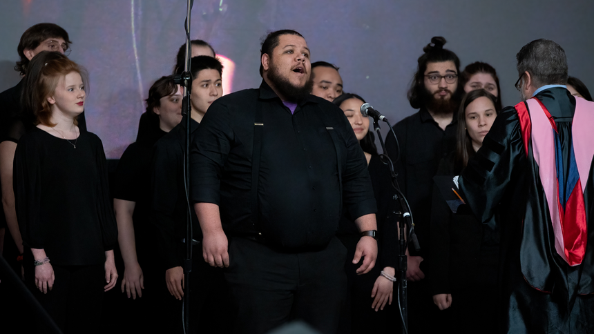 The Pacific University Chamber Singers, featuring soloist Dezmon Moon '23, sing "We Shall Overcome" at the inauguration ceremony