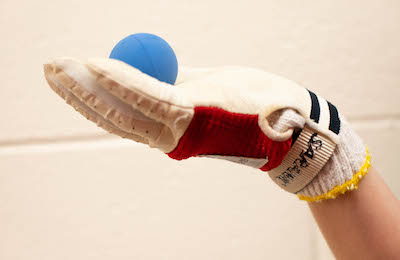 Gloved hand holding a handball