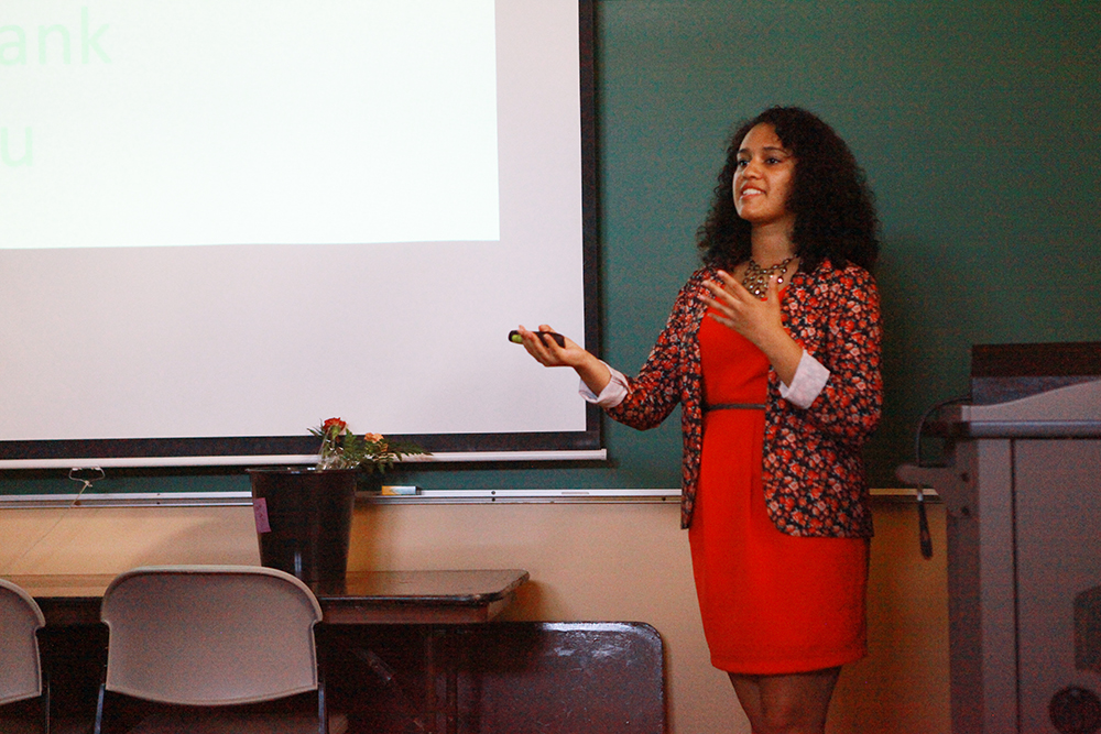 A student delivers a senior project thesis at the front of a classroom