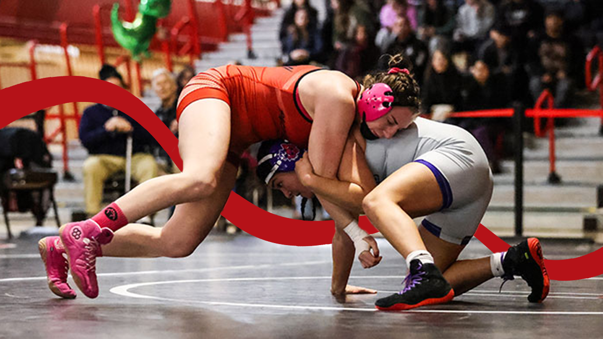 Two women wrestlers face off on the mats.
