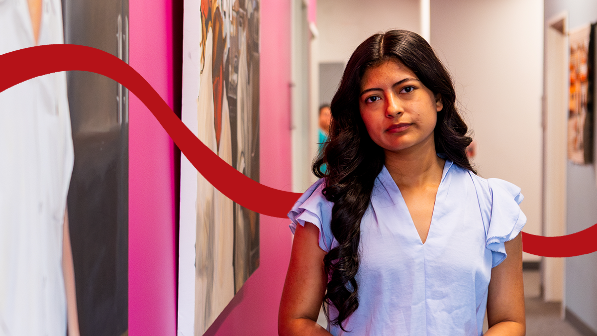 Pacific alumna Nanci Rios '19 poses in the hallway of Adelante Mujeres, where she is an immigration attorney.