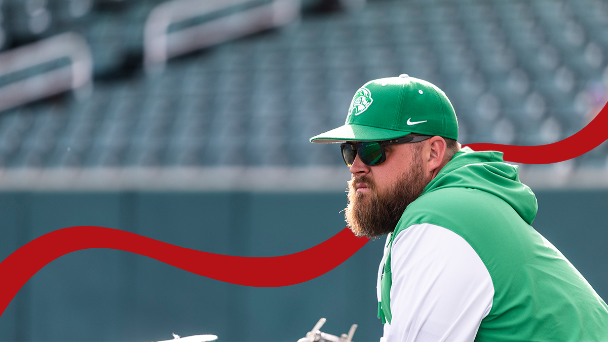 Nate Rasmussen, dressed in Ohio Valley green and sunglasses, in a baseball stadium