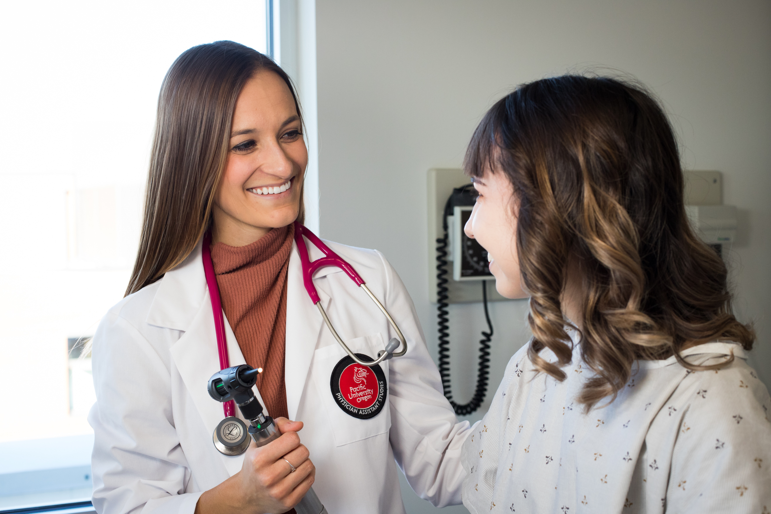 A Pacific University Physician Associate student practices with a patient
