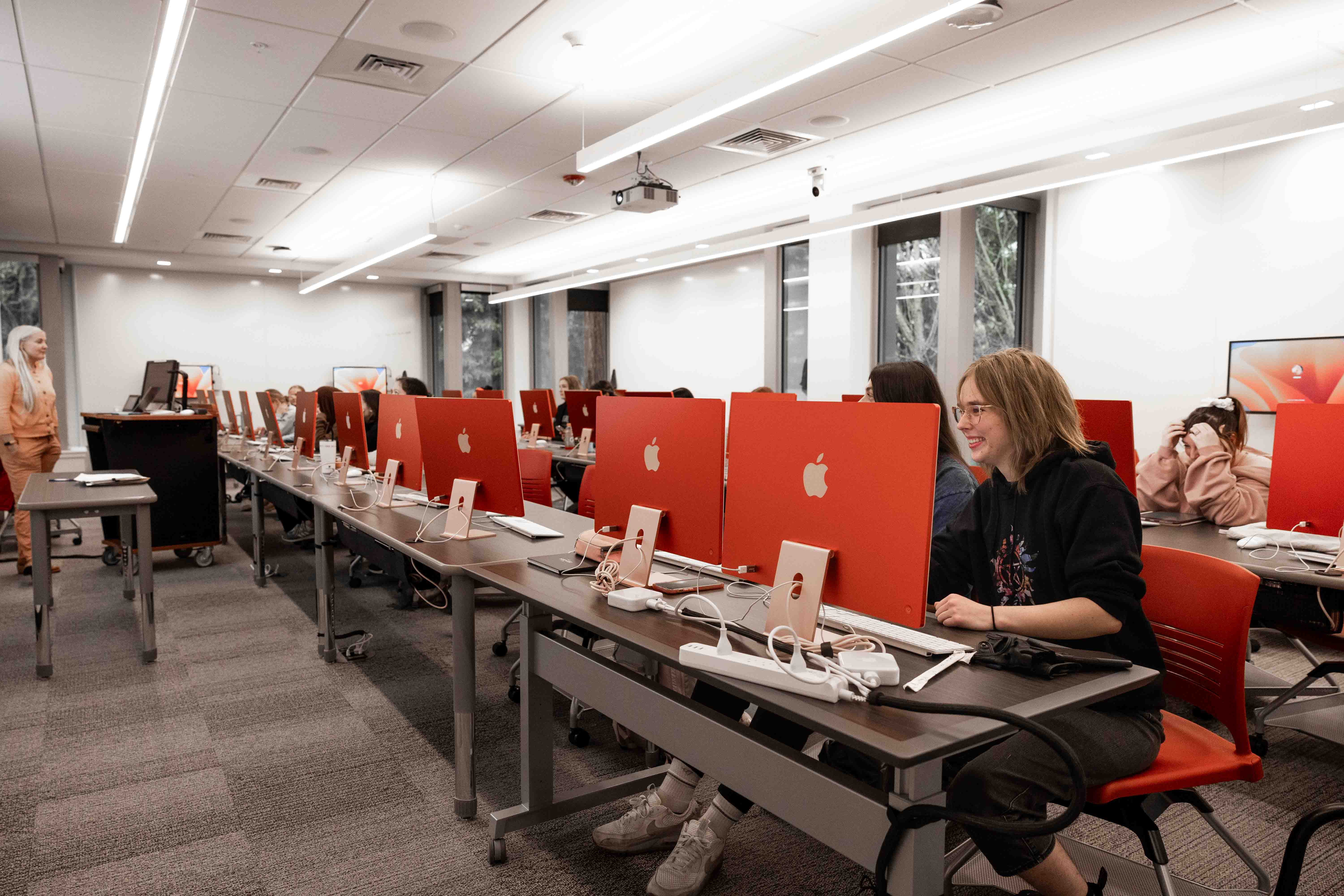 Pacific University students in computer lab with red desktops