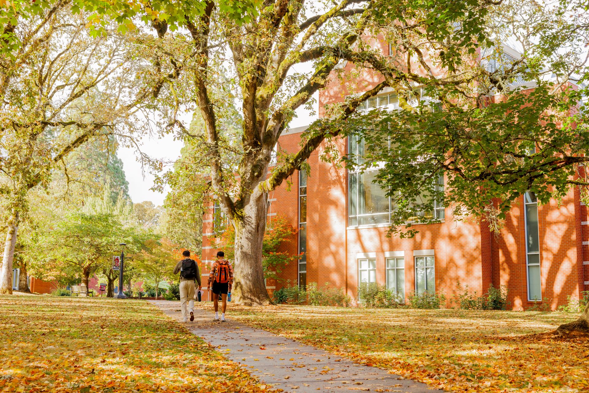 Two students strolling across campus