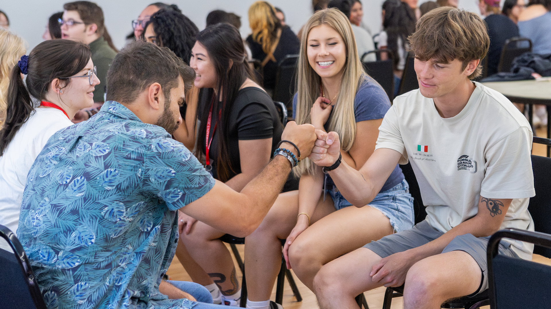 Students bump fists during an orientation activity
