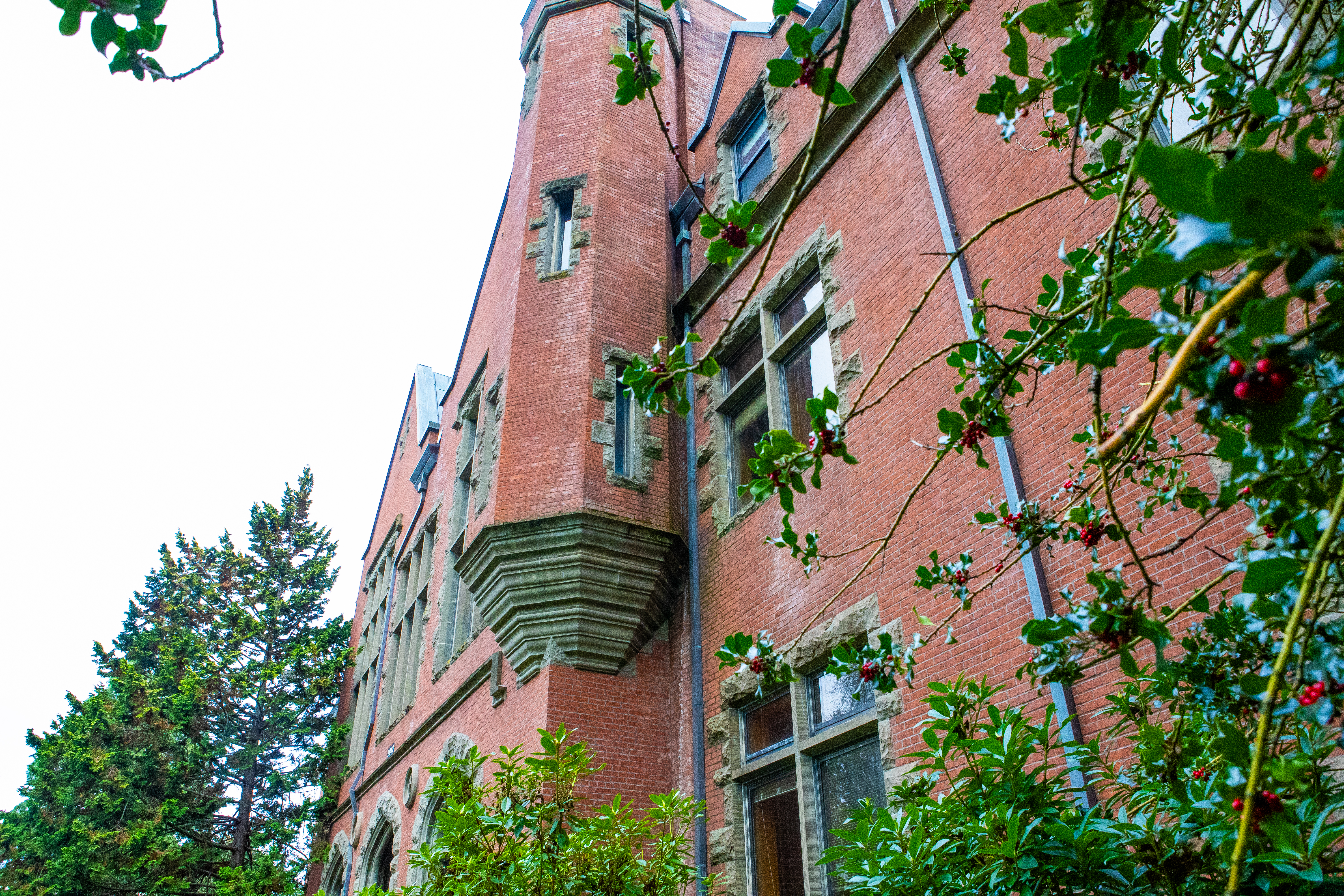 Pacific University brick campus building with greenery