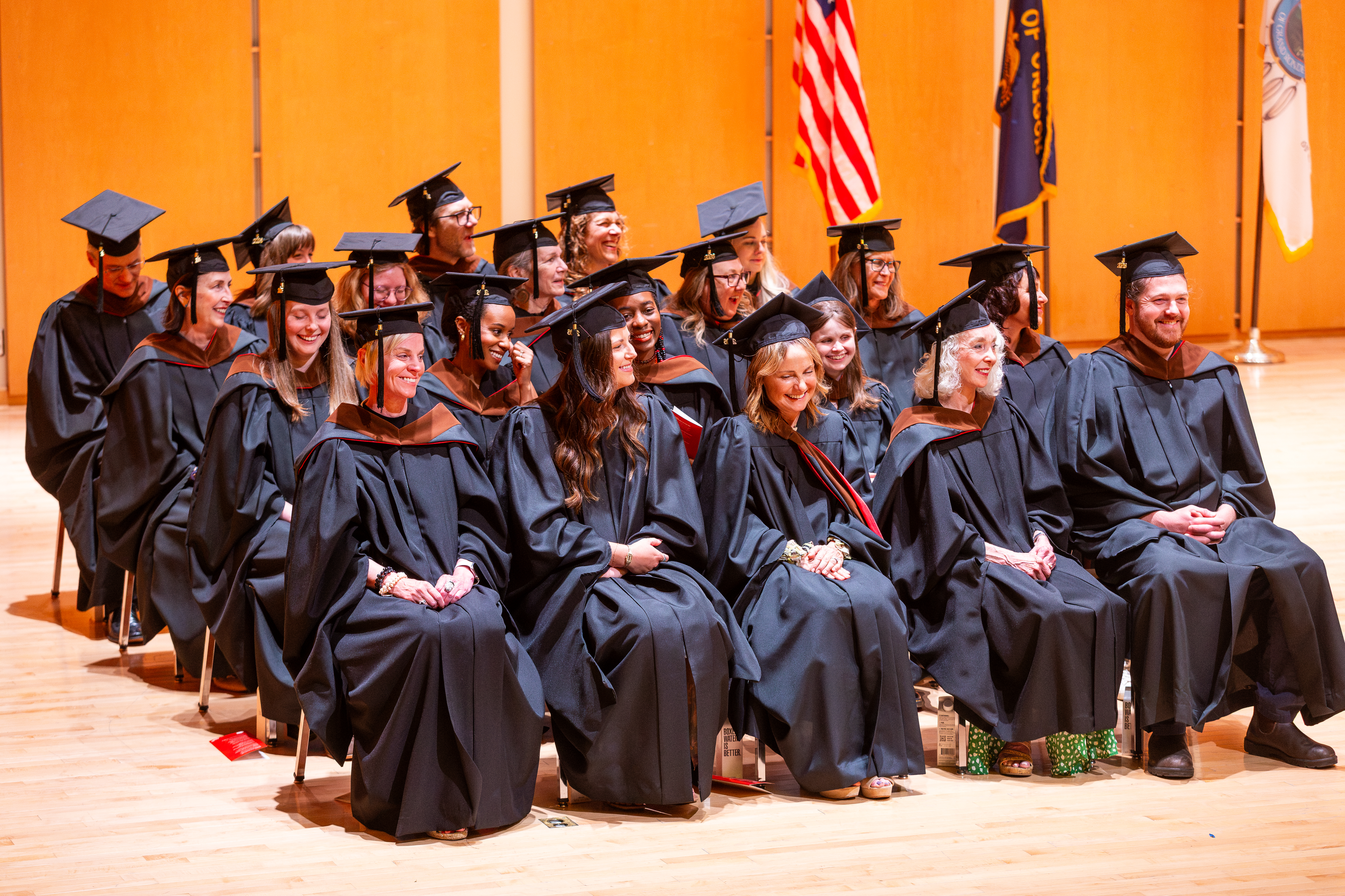 a group of Pacific University graduate students at graduation wearing black cap and gowns