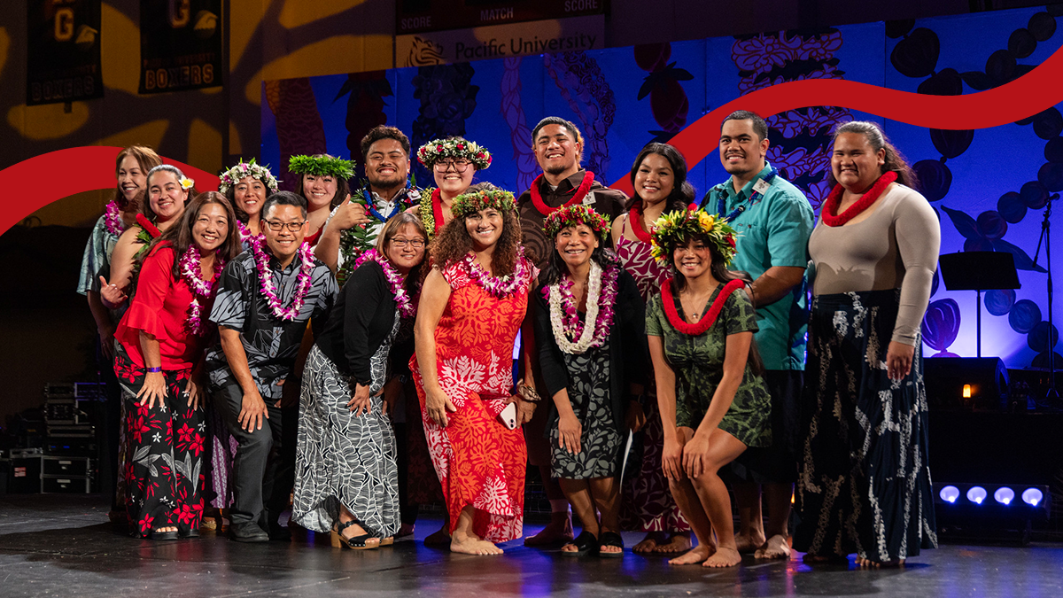 NHOH leaders pose on stage at the Lū‘au and Hō‘ike wearing floral accessories