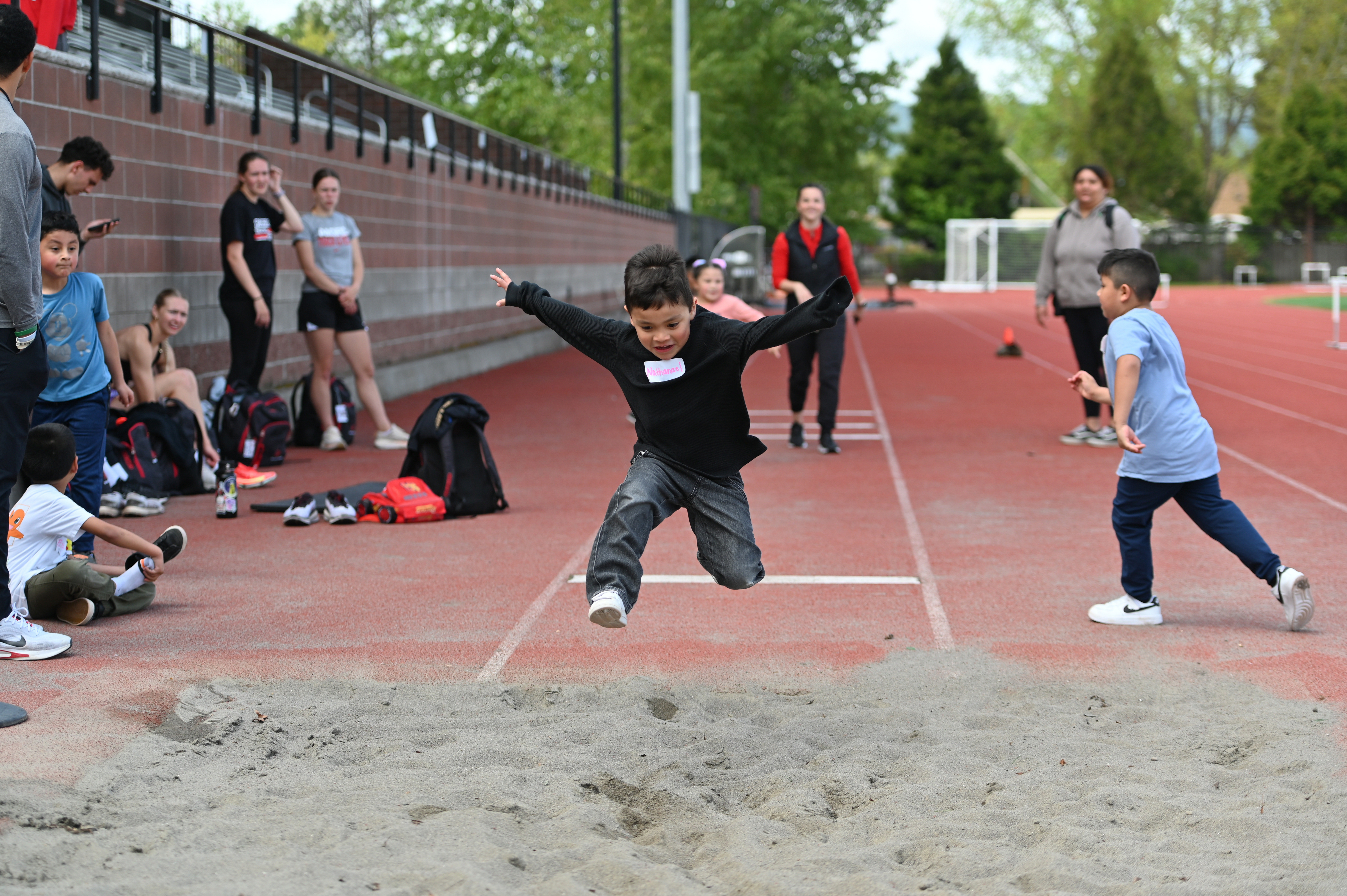Kid practicing the long jump in Hanson Stadium