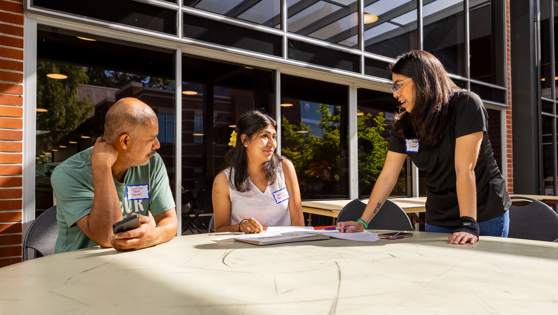 student and advisor working at a table outside