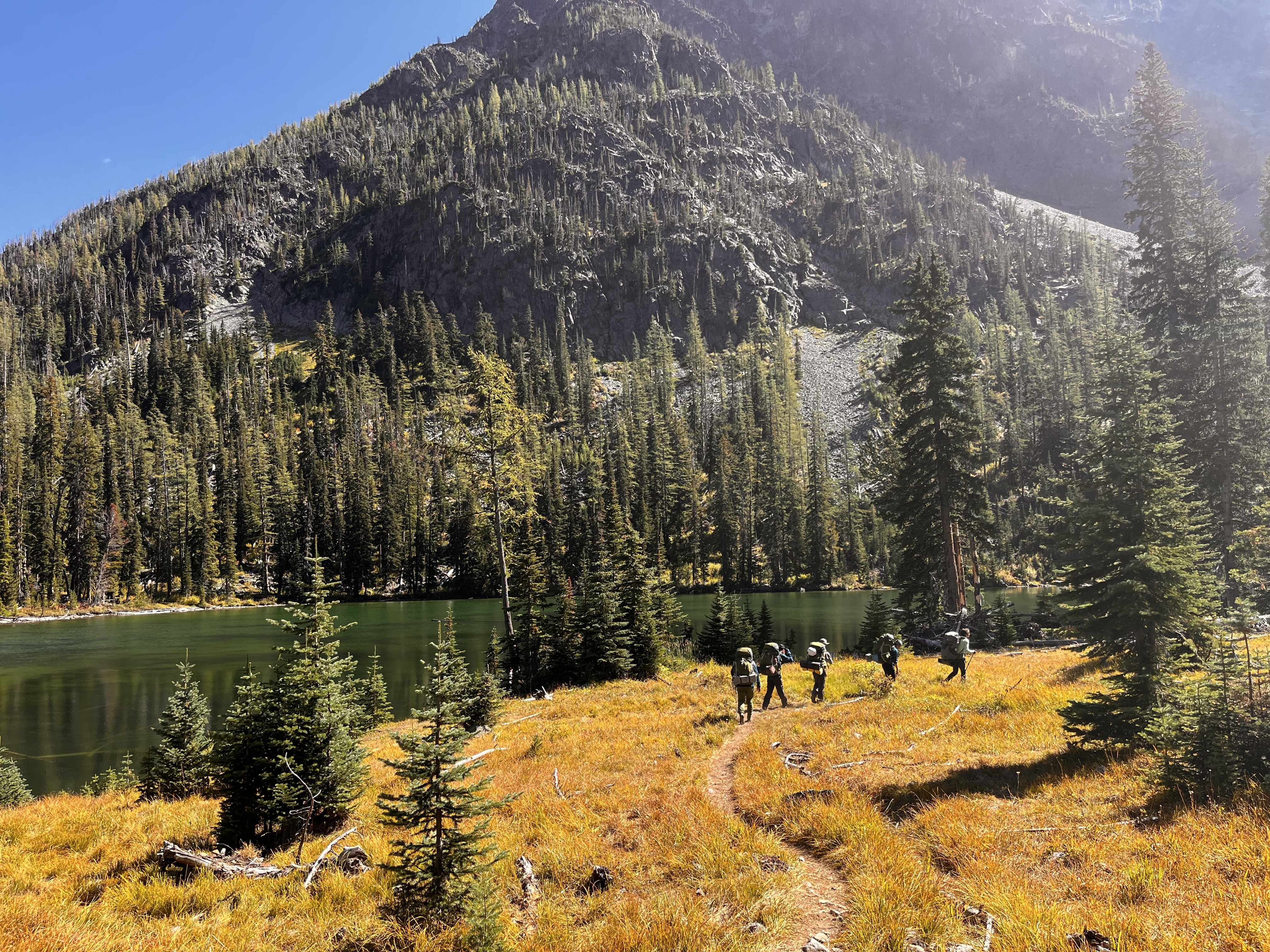 Pacific University students soaking in autumn while backpacking through North Cascades, Washington