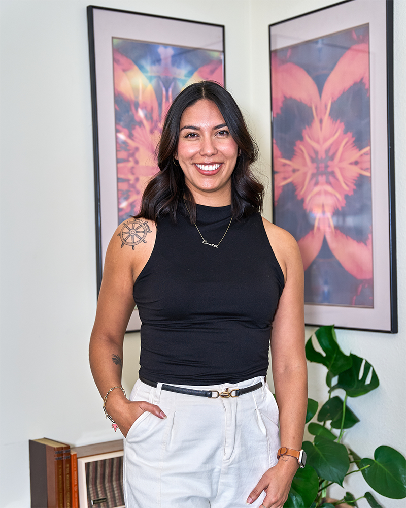 Ivette Heredia wearing a black shirt and white pants