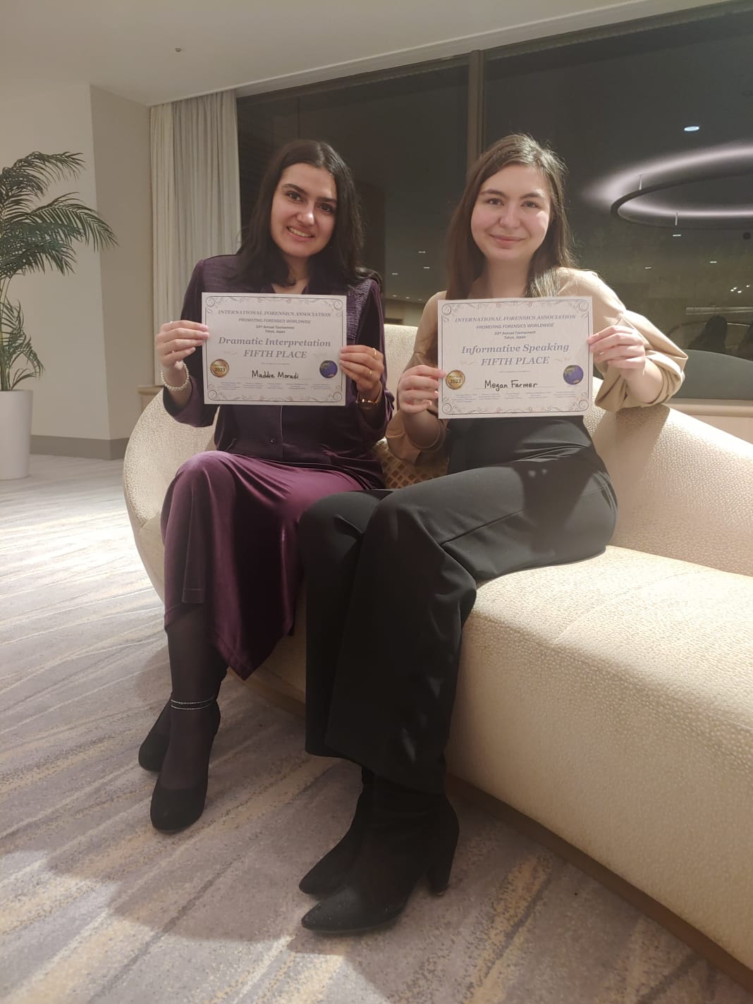 Two Pacific University debate students show off their awards