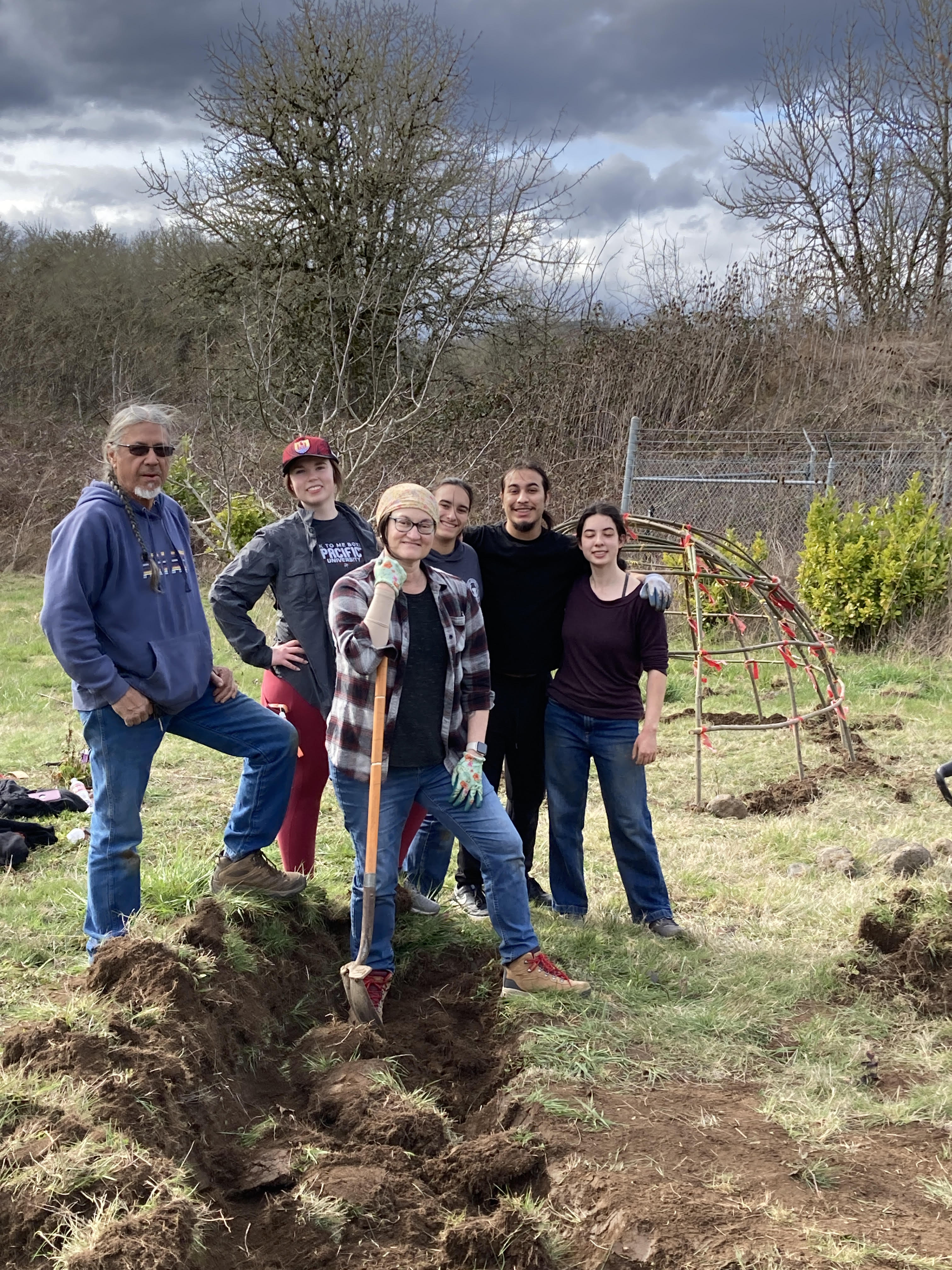 advisor and students digging in a project
