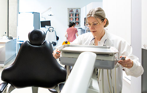 Amy Coplen works with a rectangular x-ray machine in the Pacific University dental clinic.