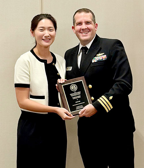 Esther Kim (left) receives award from Adam Preston