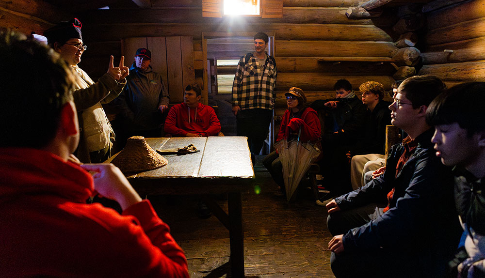 A Class Of Students Listen To A Park Guide Clad In Buckskins Inside Fort Clatsop