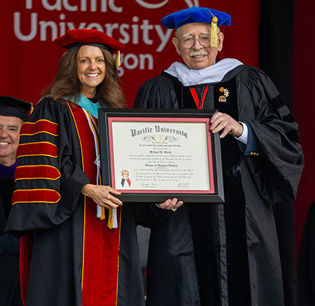 Mike Steele received his honorary Doctor of Humane Letters degree from Pacific President Jenny Coyle.