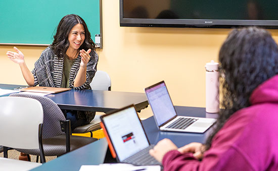 Rebecca Schoon In A Classroom Working With A Student