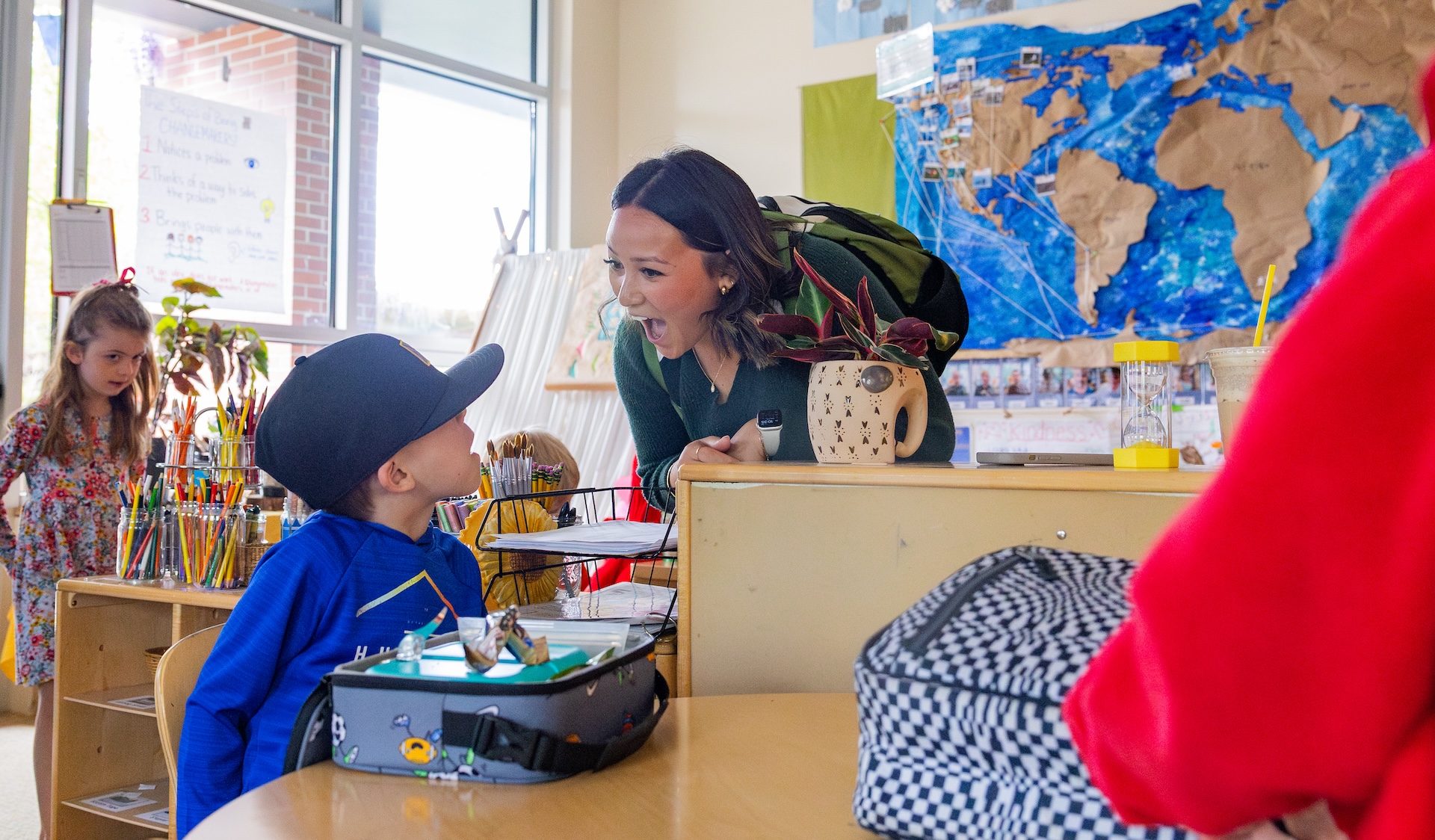 Pacific student teacher with students in a classroom