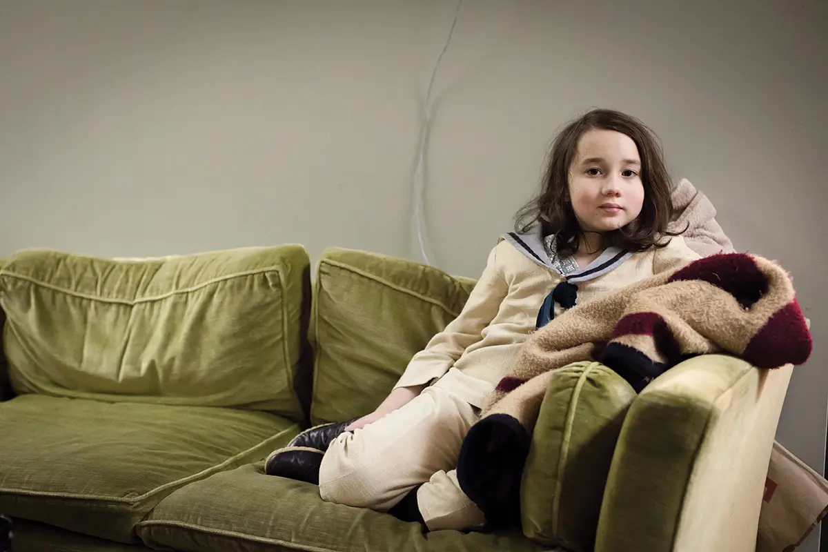 young female sitting on a couch