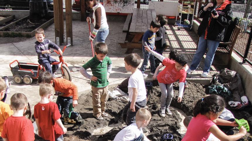 Children playing in sandbox.