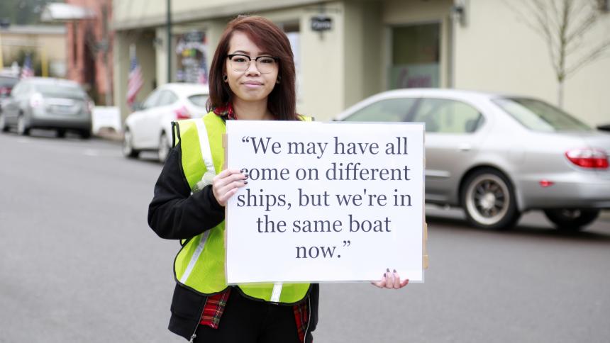 Person holding sign with a quote