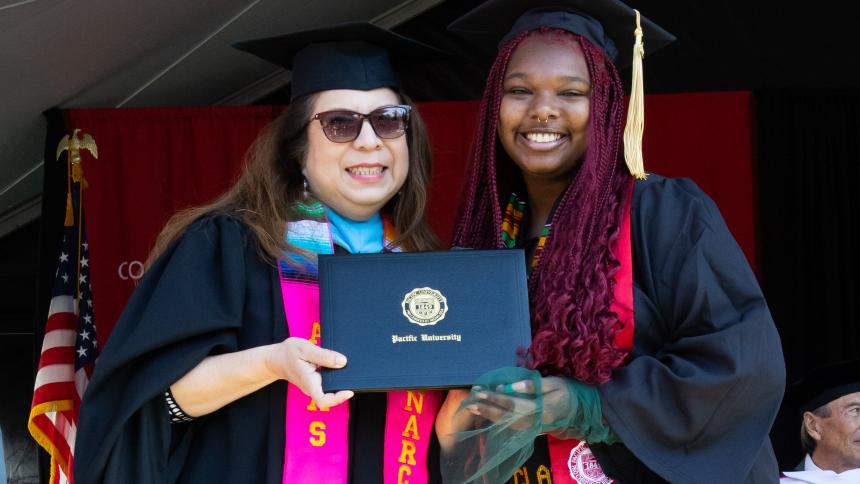 Chiffon Noble receives her diploma with Vice President Narce Rodriguez