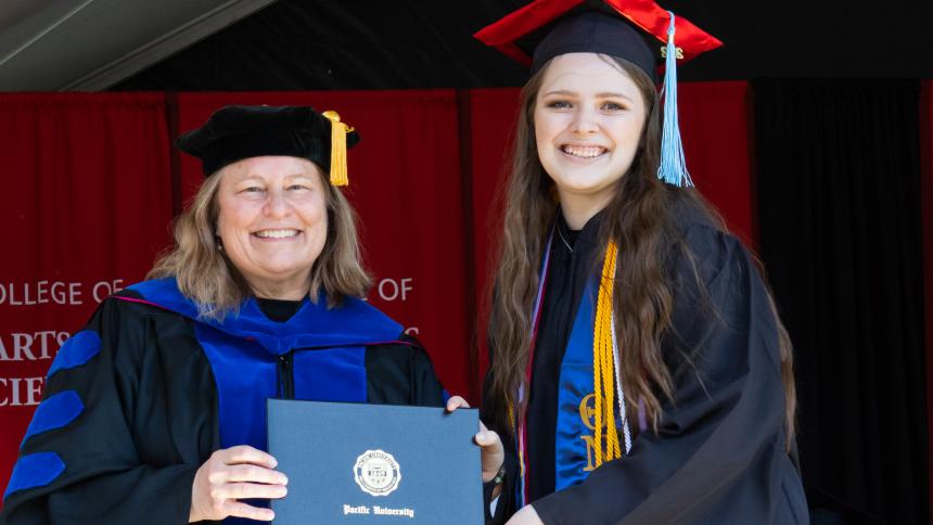Kathleen Ward '22, right, receives her diploma from College of Arts & Sciences Dean Sarah Phillips