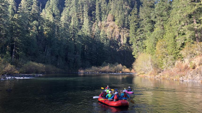 A group of students participate in the Outdoor Pursuits program by rafting down an Oregon river