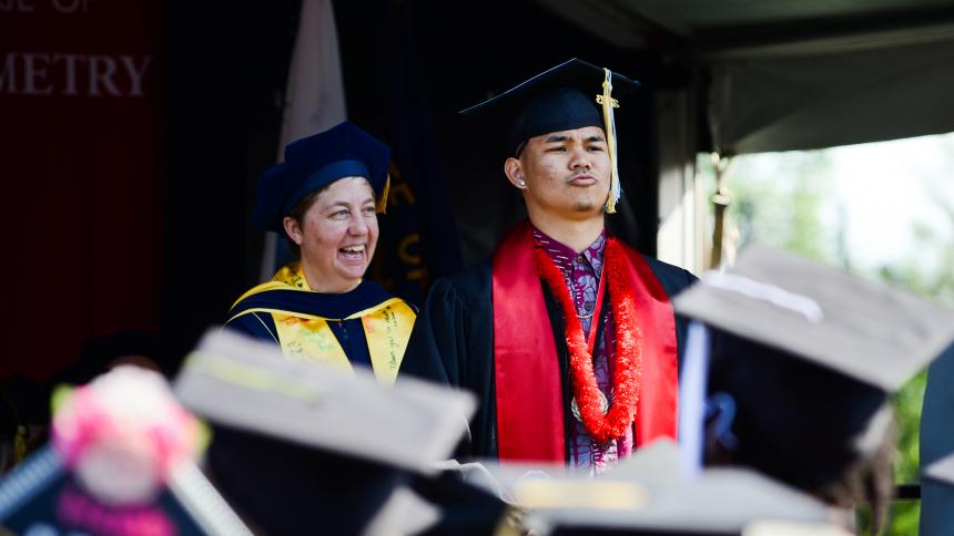 Graduate on stage at 2023 undergraduate commencement