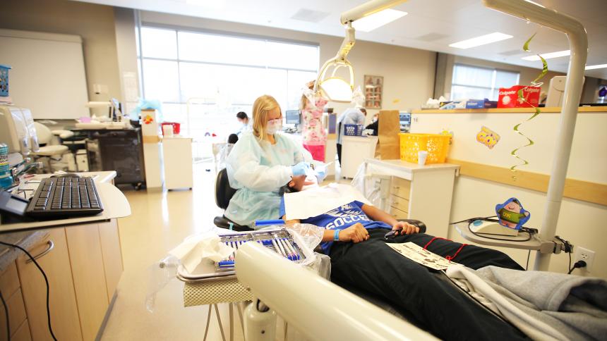 A Pacific University student treats a patient in the dental hygiene clinic.
