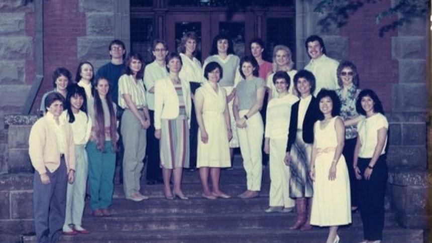Photo of the Occupational Therapy Class of 1986 on the steps of Marsh Hall on the Forest Grove Campus.