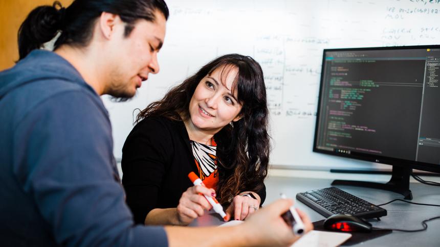 Pacific University Computer Science Professor Shereen Khoja works with student Tomy Perez-Torres '19