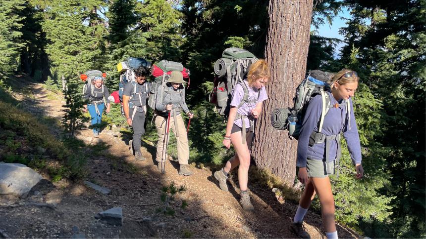 Students backpacking in a line on the Fall Break Backpacking Trip 2022