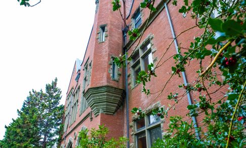 Pacific University brick campus building with greenery