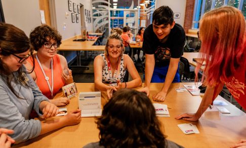 Pacific University students get to know one another over a card game during new student orientation.