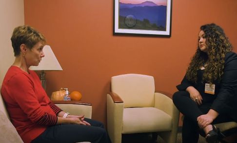Social worker Daisy Rizo speaks to a client at Providence's St. Vincent Medical Center. 